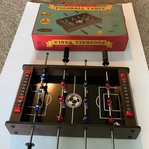 Table top foosball table includes two soccer balls